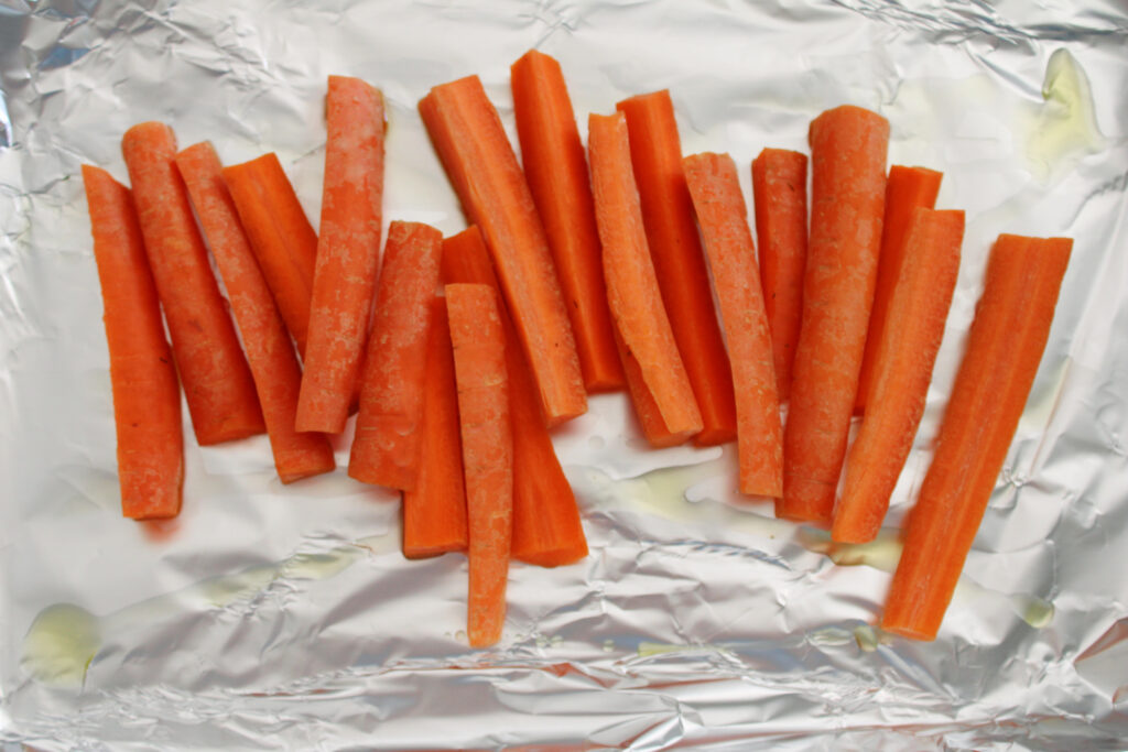 Chopped and peeled carrots on a sheet of foil.