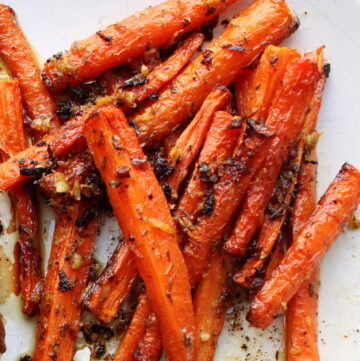 Roasted carrots with seasoning on top.