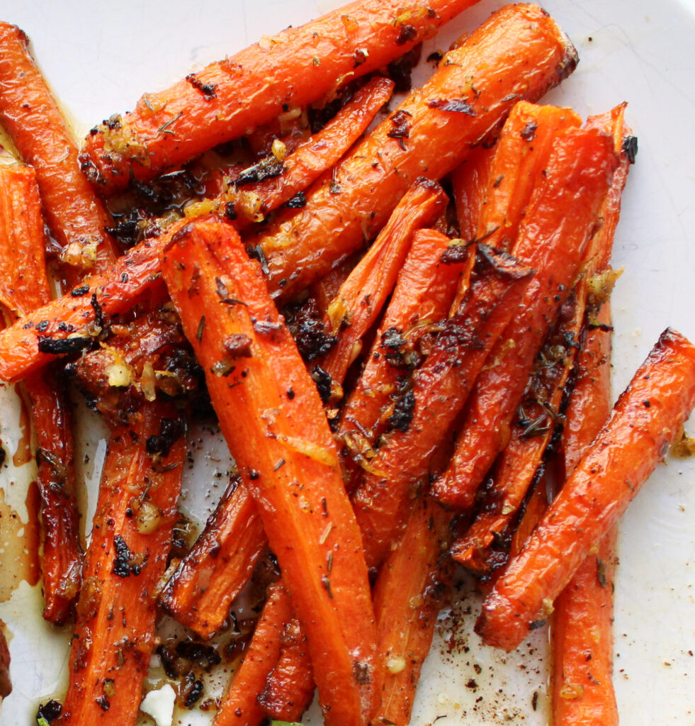 Oven roasted carrots with seasoning on top.
