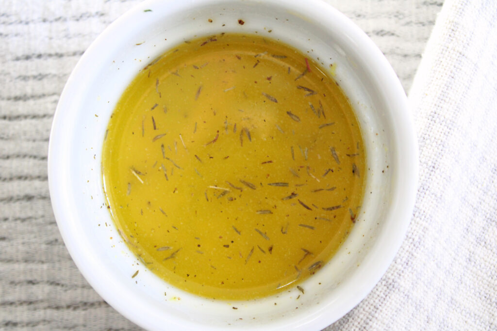 Melted butter for The Best Oven Roasted Carrots with Lemon and Thyme in a small bowl.