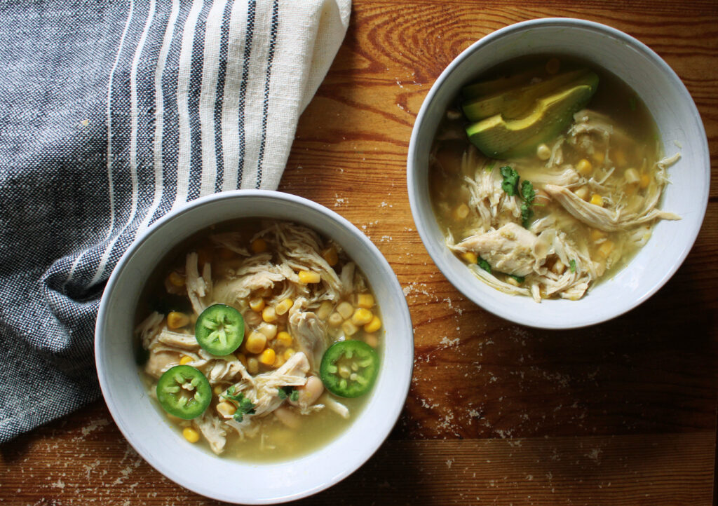 Slow Cooker White Chicken Chili on wooden table.