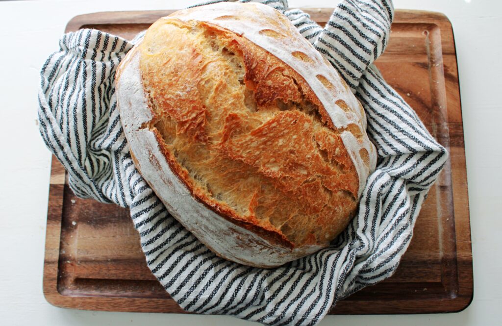 Same day sourdough loaf on a cutting board.