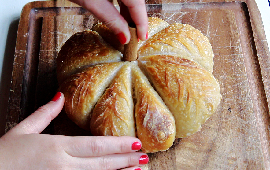 Pumpkin shaped sourdough final loaf on a cutting board.