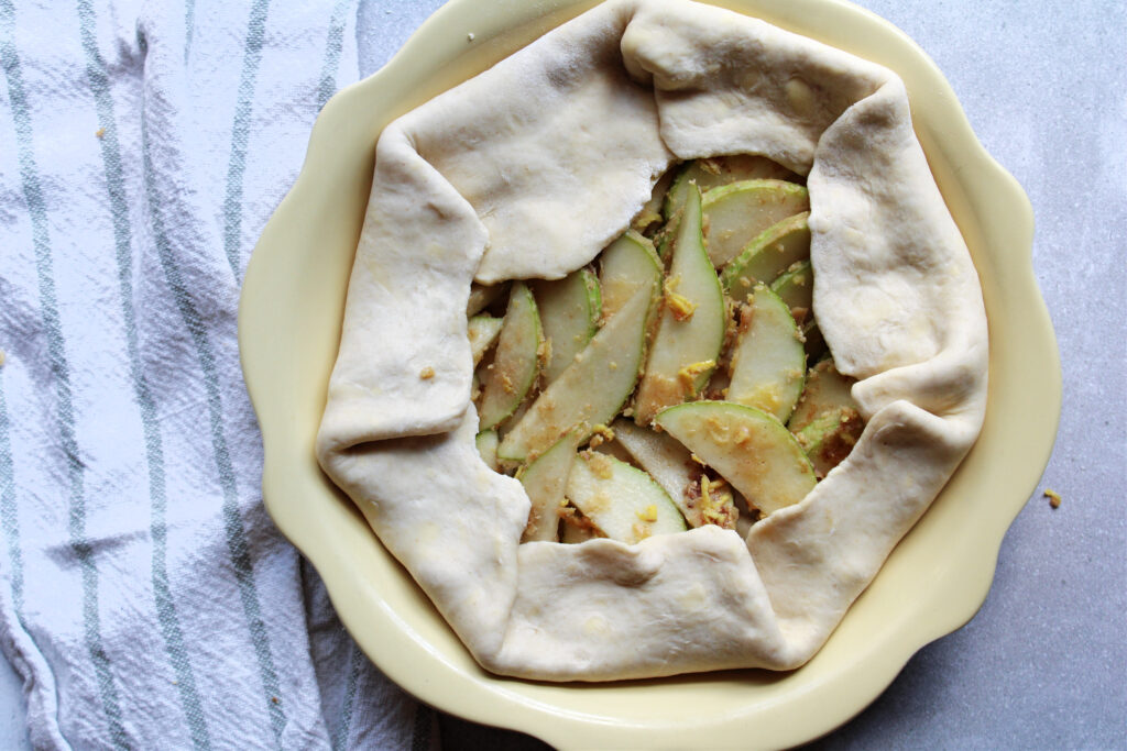 Close up of the pear and ginger galette filling and the pie crust folded over the filling.