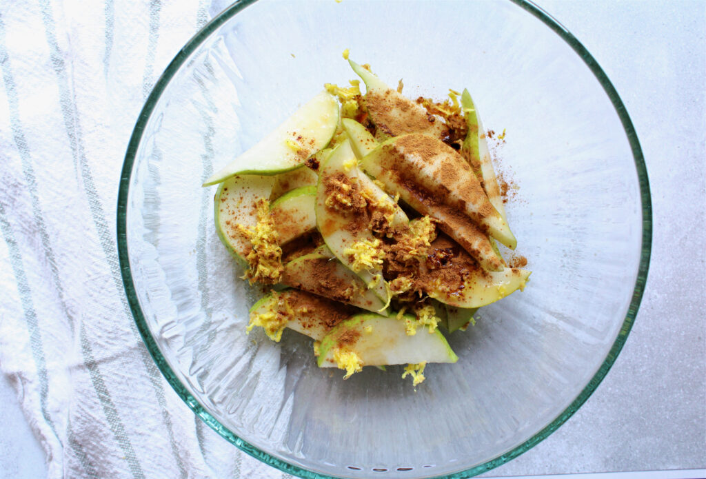pear and ginger galette filling ingredients in a clear bowl.