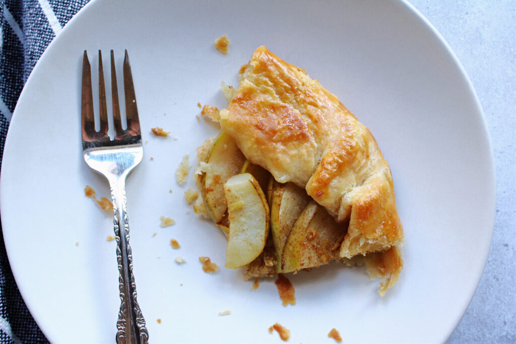 Slice of pear and ginger galette served on a plate.
