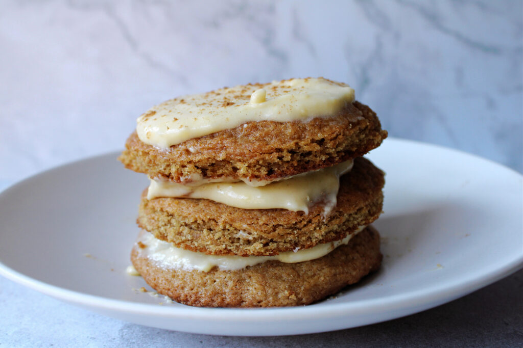 sourdough discard pumpkin spice cookies stacked on a white plate