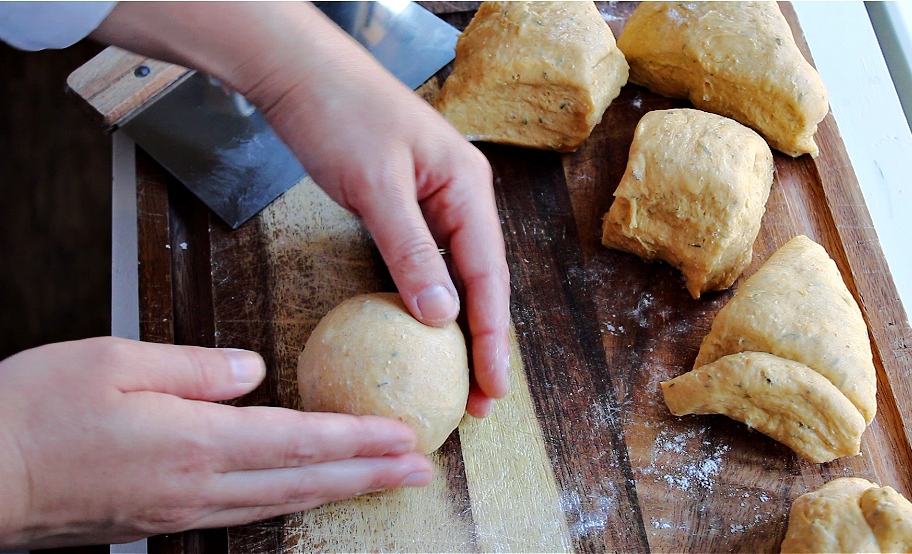 Hands rolling dough being prepped for fall baking.