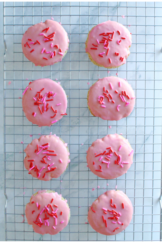 sourdough sugar cookies with pink frosting and sprinkles.