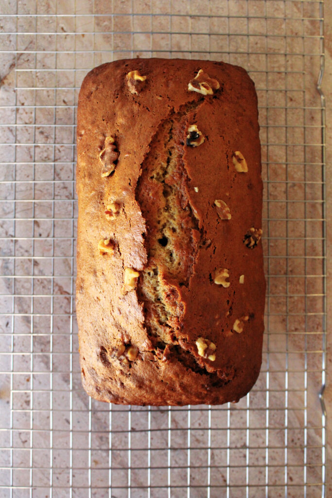banana bread baked and cooling on a cooling rack.