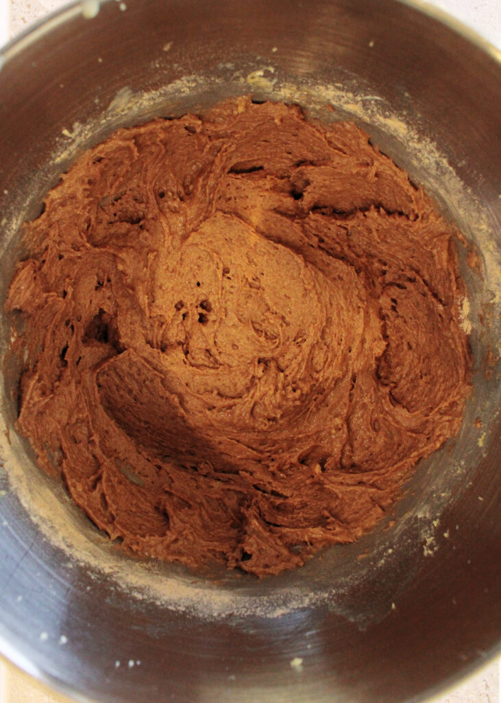 Chocolate chip sourdough cupcake batter in a mixing bowl.