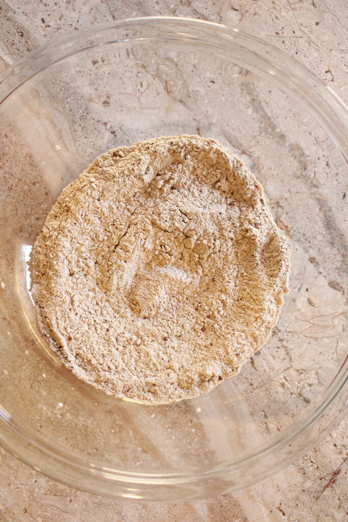 Dry ingredients for sourdough chocolate chip cupcakes in a bowl on the counter.