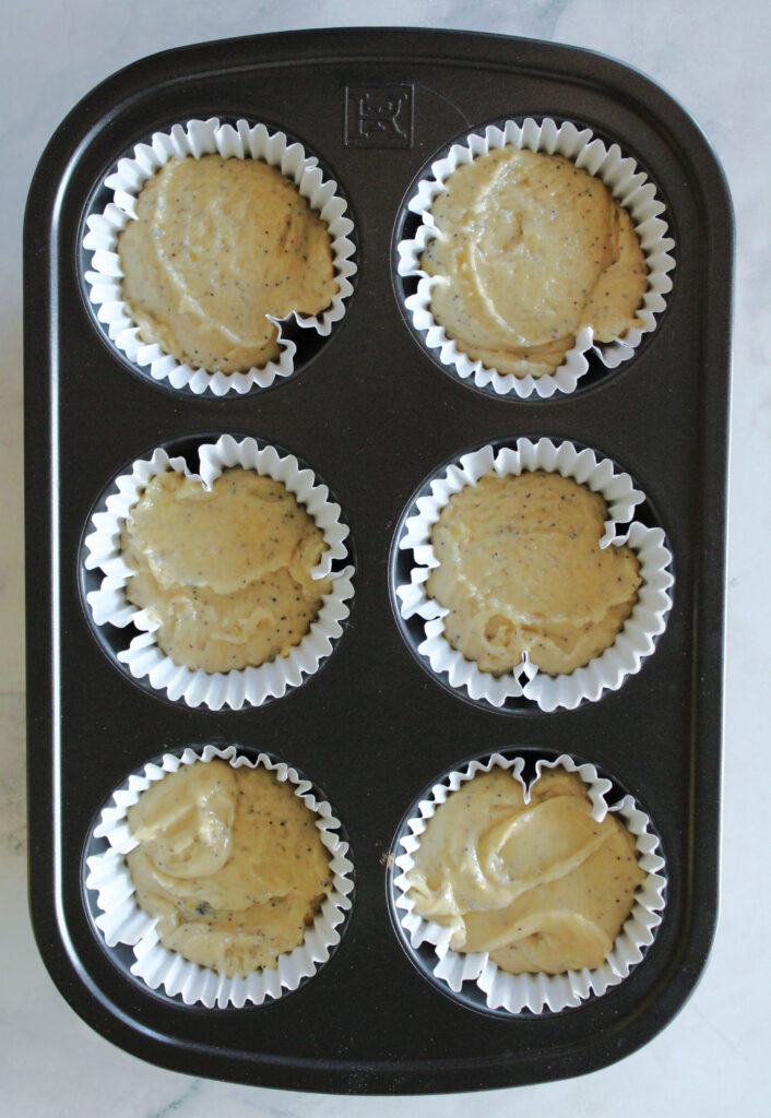 Sourdough discard lemon poppy seed muffin batter in a muffin tin.