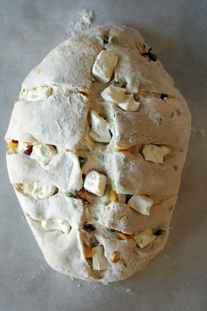 japaleno popper sourdough bread with cream cheese squares inside.
