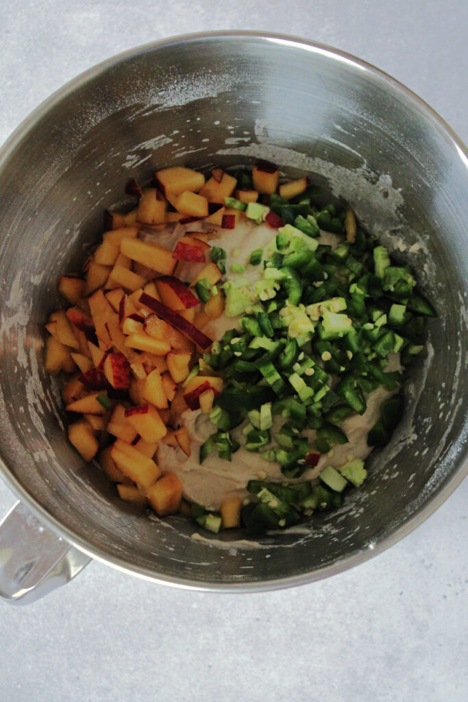 jalapenos and peaches on top of sourdough in a mixing bowl.