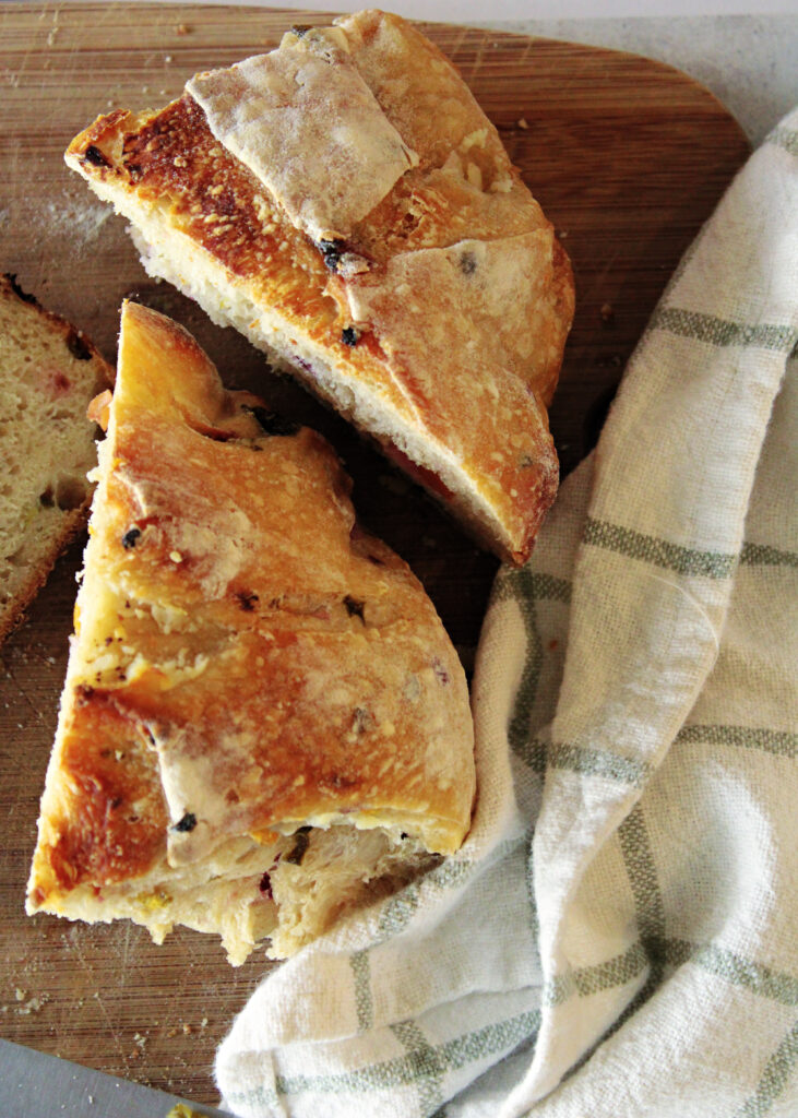 Jalapeno popper sourdough bread sliced on a cutting board