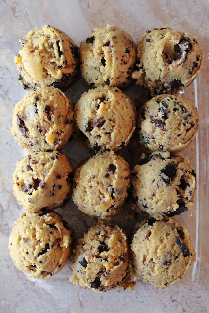 Salted caramel peanut butter cup cookies scoops in a glass container.