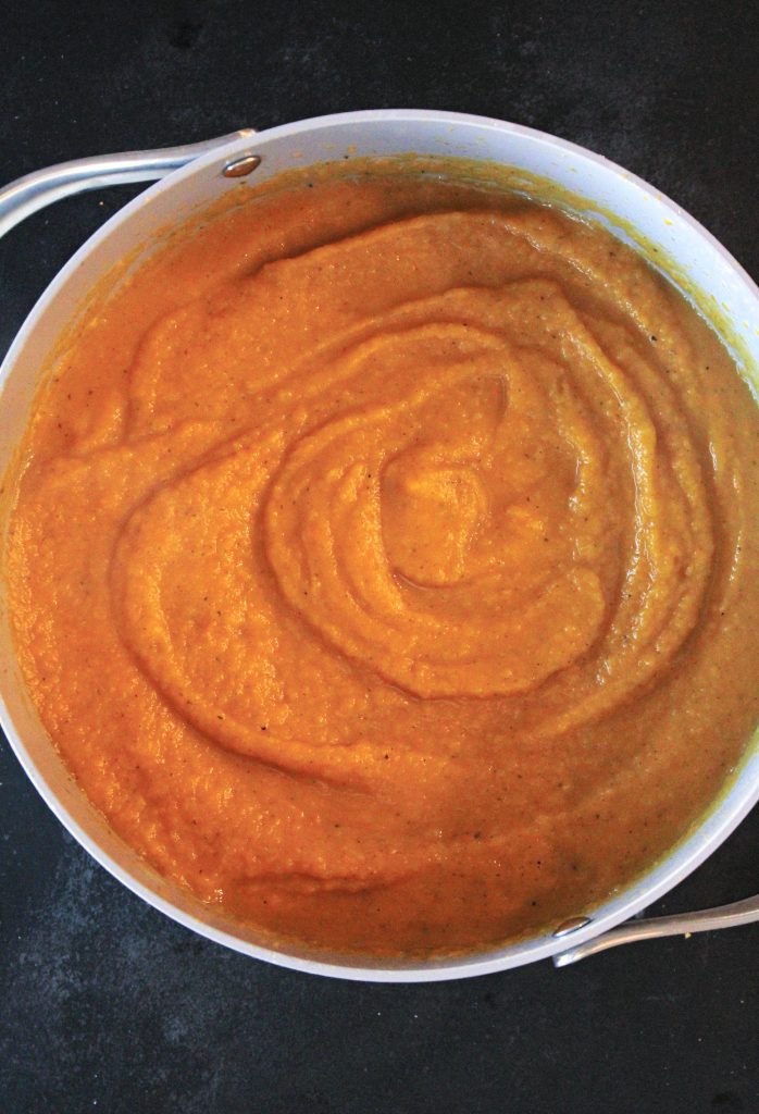 Butternut squash and carrots blended up in a stock pot.