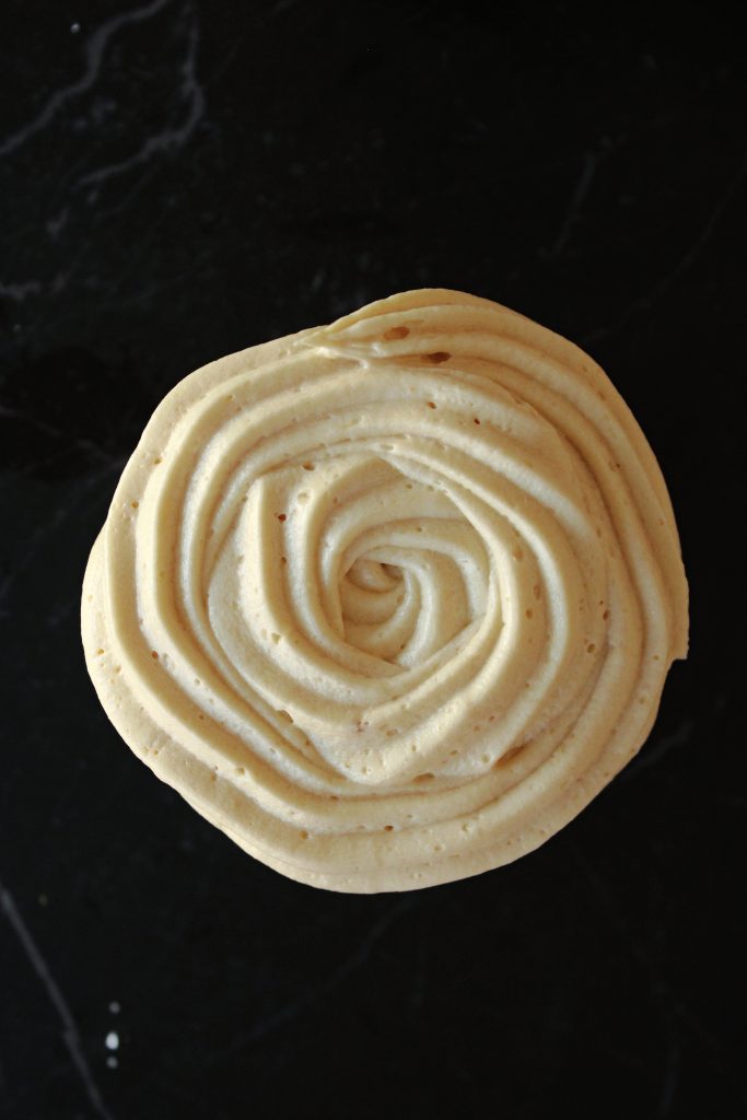Cinnamon Cupcake with Cookie Butter Frosting sitting on the counter.